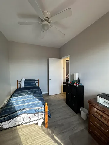 a bedroom with a bed and dresser