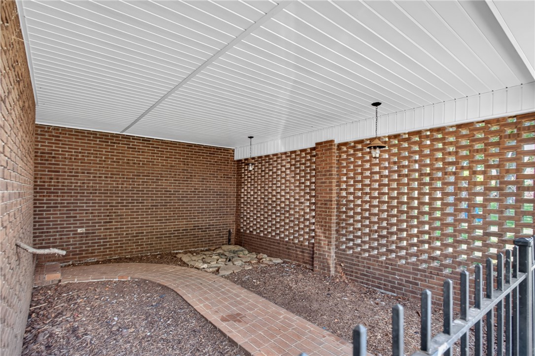 1412 Simpson Road Pendleton, SC 29670 - Photo 36 of 48 Brickwork with geometric patterns forms a private exterior alcove with a charming paved pathway.