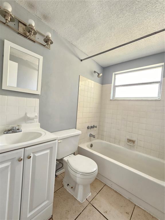 7825 Sagebrush Drive Port Richey, FL 34668 - Photo 11 of 17 a bathroom with a sink a toilet a mirror and shower