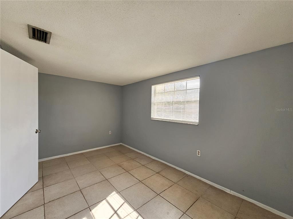 7825 Sagebrush Drive Port Richey, FL 34668 - Photo 12 of 17 an empty room with windows