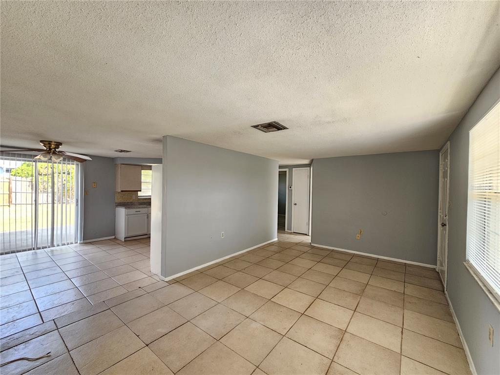 7825 Sagebrush Drive Port Richey, FL 34668 - Photo 4 of 17 a view of an empty room and window