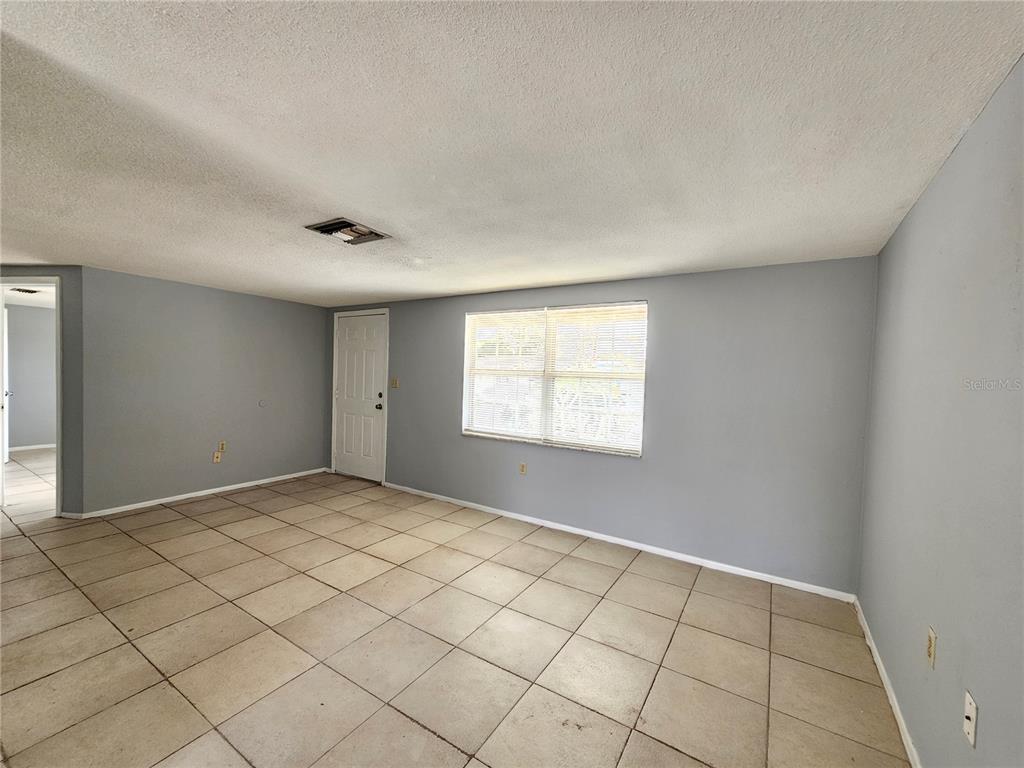 7825 Sagebrush Drive Port Richey, FL 34668 - Photo 5 of 17 a view of an empty room and window