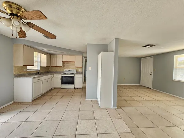 a large kitchen with cabinets and stainless steel appliances