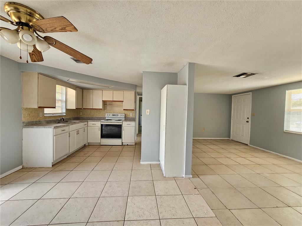 7825 Sagebrush Drive Port Richey, FL 34668 - Photo 6 of 17 a large kitchen with cabinets and stainless steel appliances