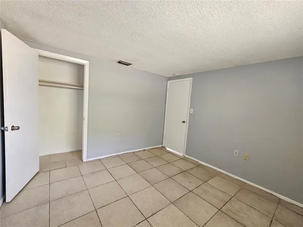 a view of an empty room and wooden floor
