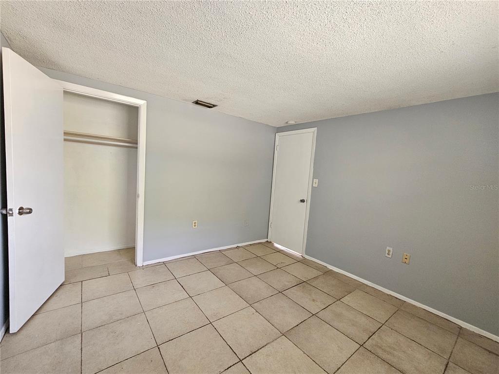 7825 Sagebrush Drive Port Richey, FL 34668 - Photo 10 of 17 a view of an empty room and wooden floor