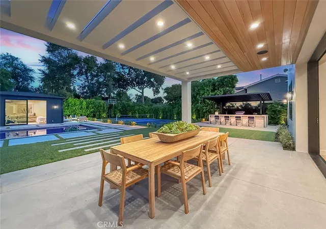 an aerial view of a house with a yard and a large tree