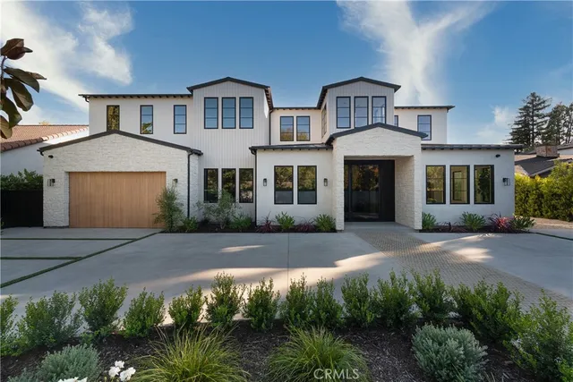 a view of a house with pool and chairs