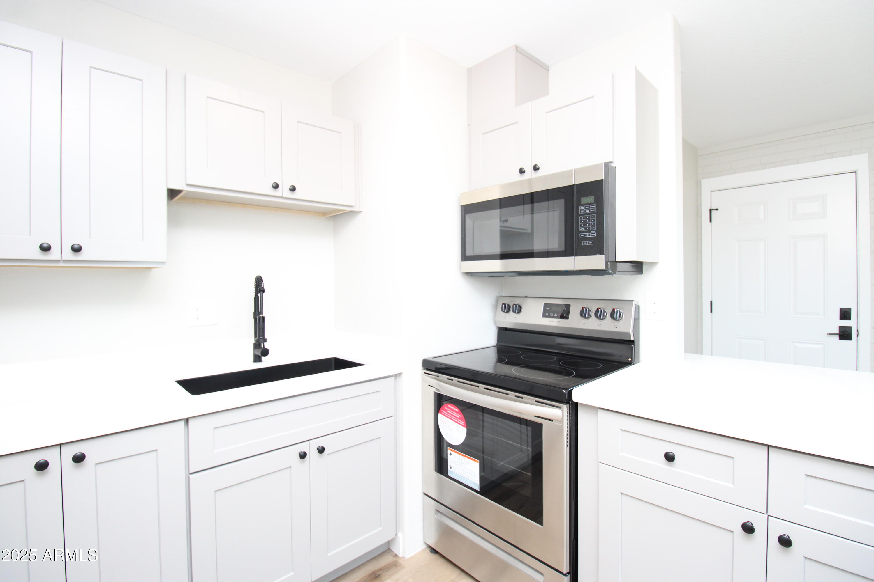 802 South 11th Avenue, Unit 4 Phoenix, AZ 85007 - Photo 2 of 11 a kitchen with cabinets appliances and a sink