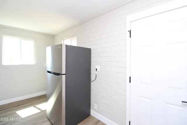 a kitchen with a refrigerator and window