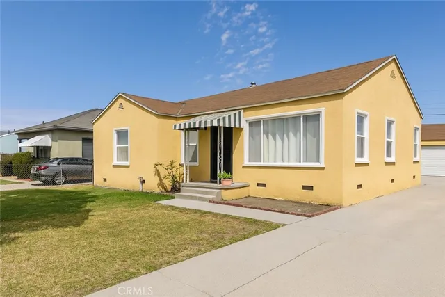 a front view of a house with a yard outdoor seating and garage