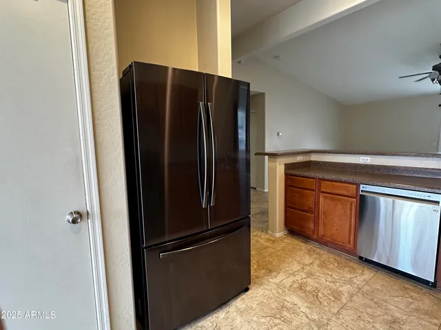 a kitchen with stainless steel appliances granite countertop a refrigerator and a sink