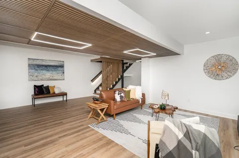 a room with gym equipment and wooden floor