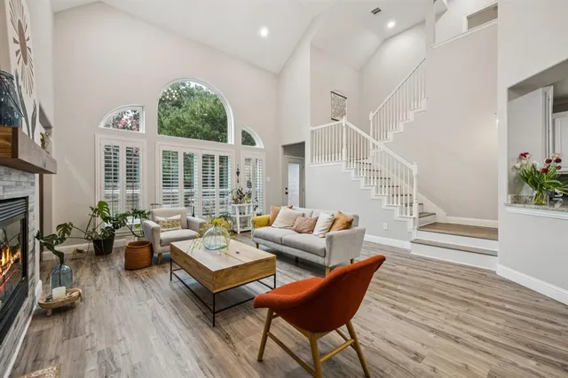 a living room with furniture a fireplace and a potted plant