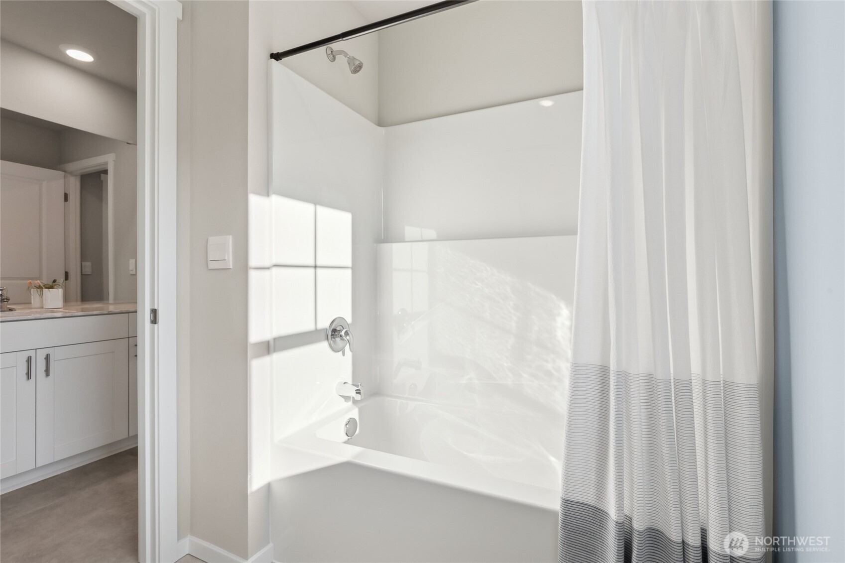 201 Cremini Loop Southeast, Unit 53 Lacey, WA 98513 - Photo 7 of 16 a bathroom with a bathtub and a shower