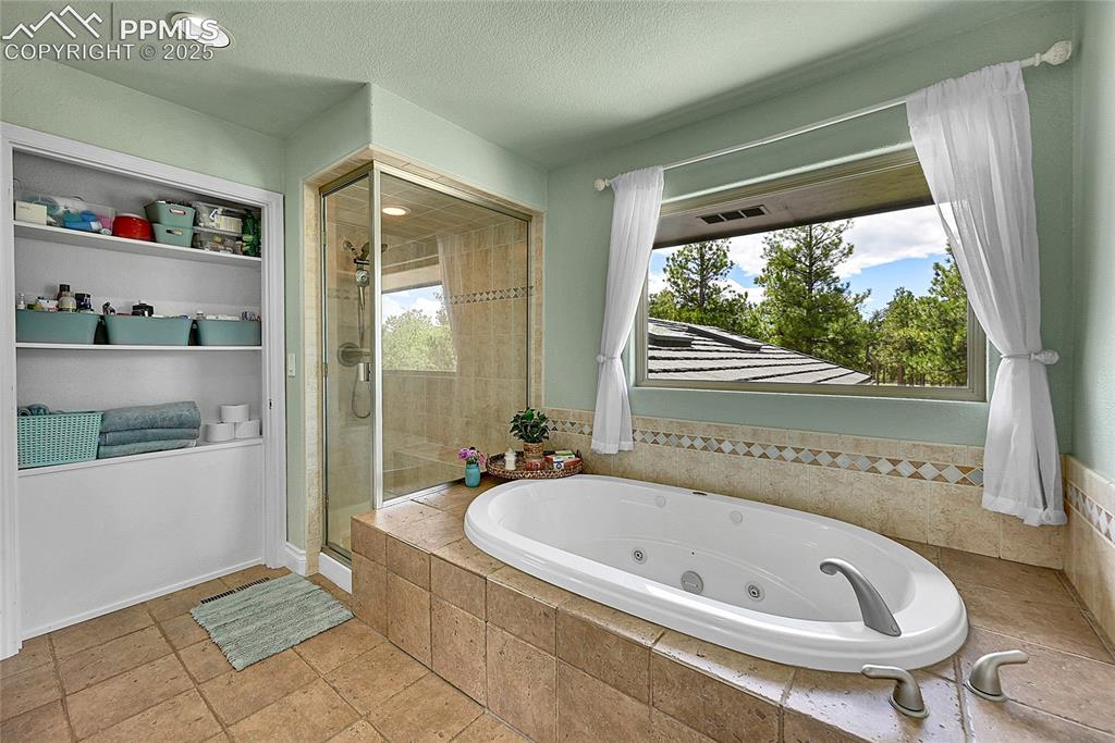 17350 Goshawk Road Colorado Springs, CO 80908 - Photo 23 of 50 a bathroom with a bathtub and a shower