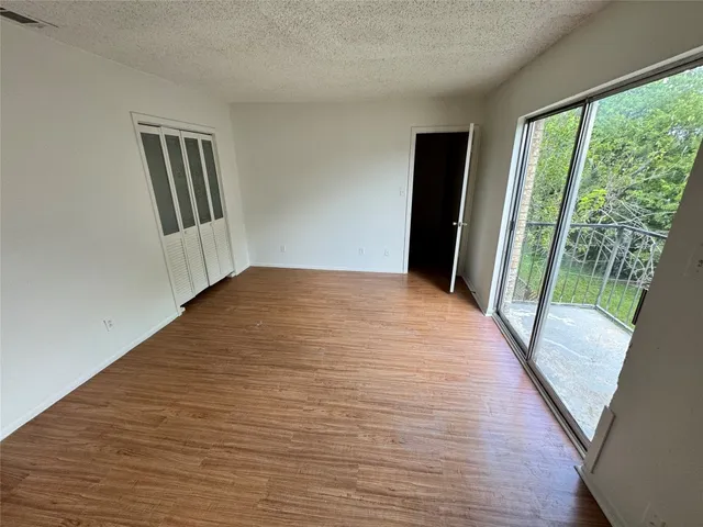 a view of a room with wooden floor and stairs
