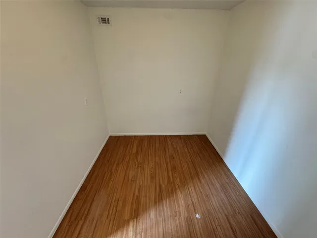 a view of wooden floor in a hallway