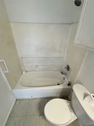 a bathroom with a toilet and a bathtub