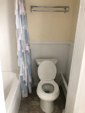 a bathroom with a toilet and a shower