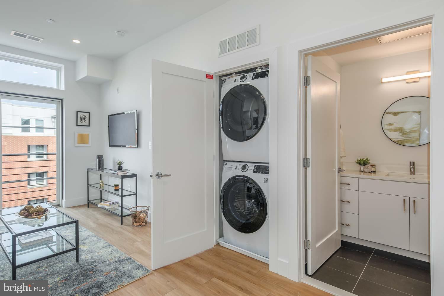 2310 4th Street Northeast, Unit 4TH 22 Washington, DC 20002 - Photo 13 of 18 a view of a hallway with washer and dryer