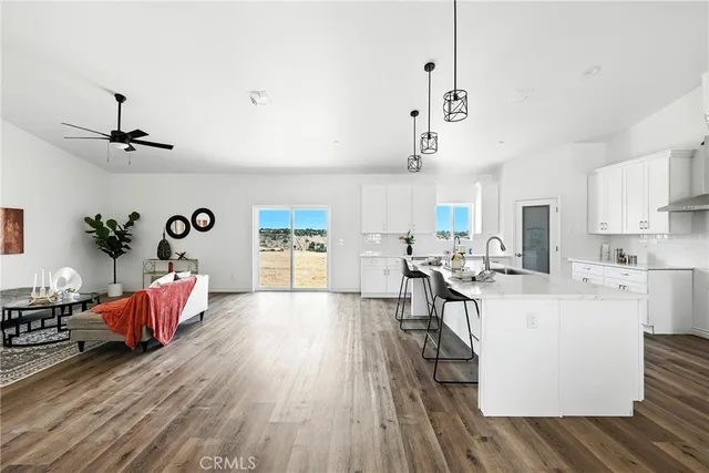 a living room with furniture and kitchen view