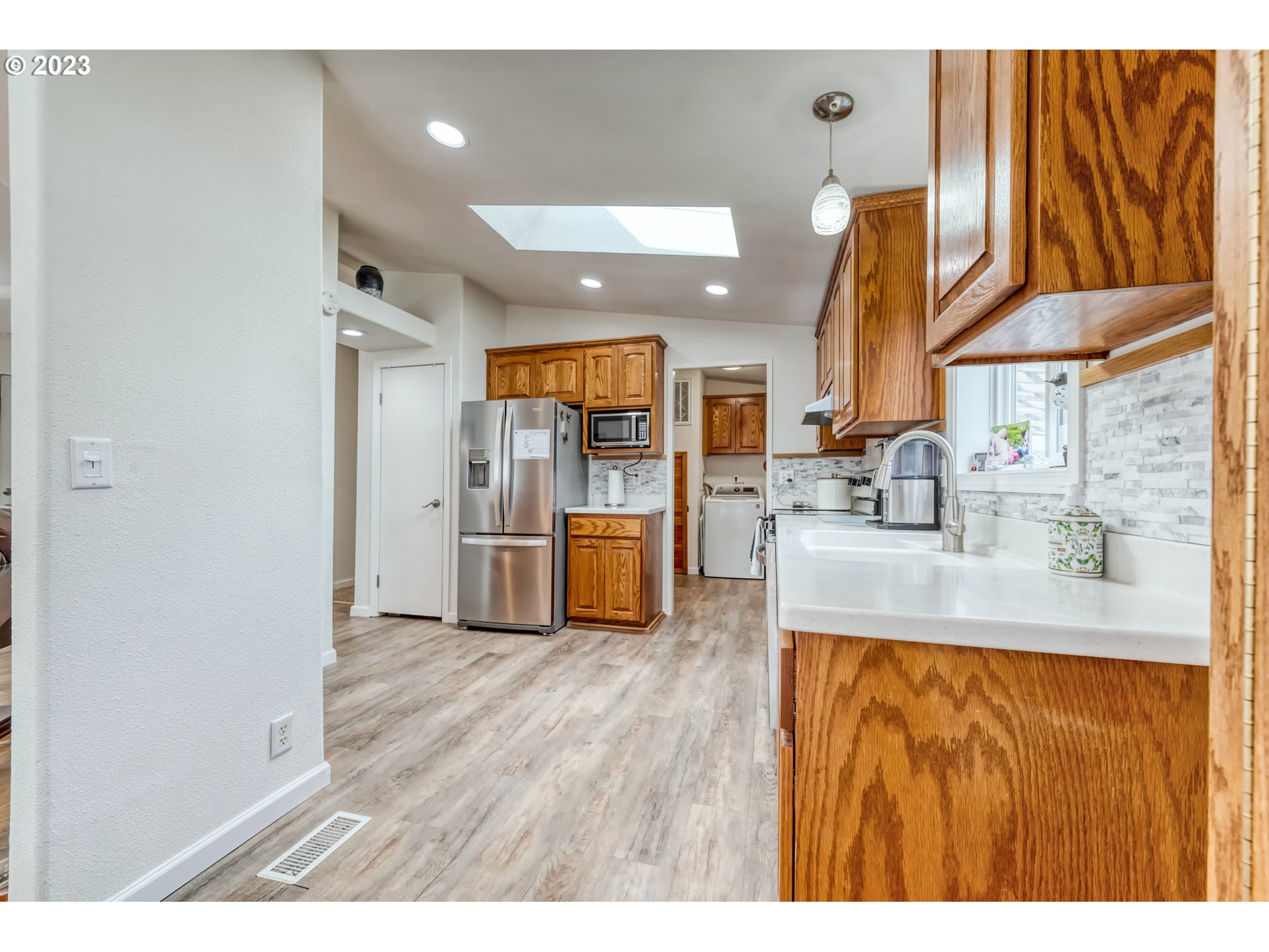 2580 Maia Loop Springfield, OR 97477 - Photo 9 of 29 a kitchen with stainless steel appliances granite countertop a sink and a refrigerator