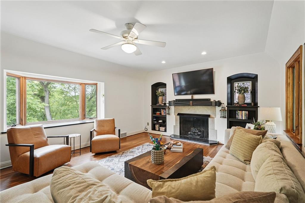 30 Club Road Carnegie, PA 15106 - Photo 20 of 49 a living room with furniture a fireplace and a flat screen tv