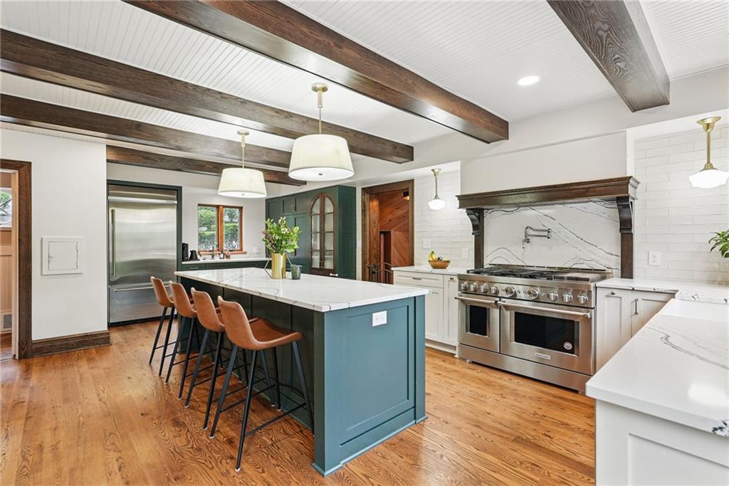 30 Club Road Carnegie, PA 15106 - Photo 26 of 49 a kitchen with a stove a refrigerator and a dining table