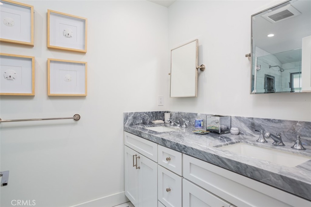 704 Emerald Bay Laguna Beach, CA 92651 - Photo 20 of 27 a bathroom with a granite countertop sink and a mirror