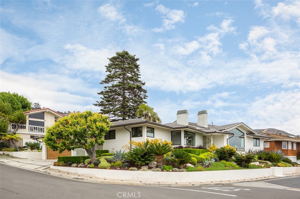 704 Emerald Bay Laguna Beach, CA 92651 - Photo 4 of 27 a front view of a house with a garden