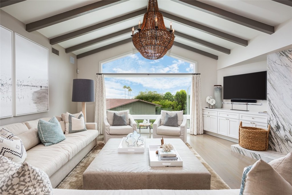 704 Emerald Bay Laguna Beach, CA 92651 - Photo 6 of 27 a living room with furniture a flat screen tv and a floor to ceiling window