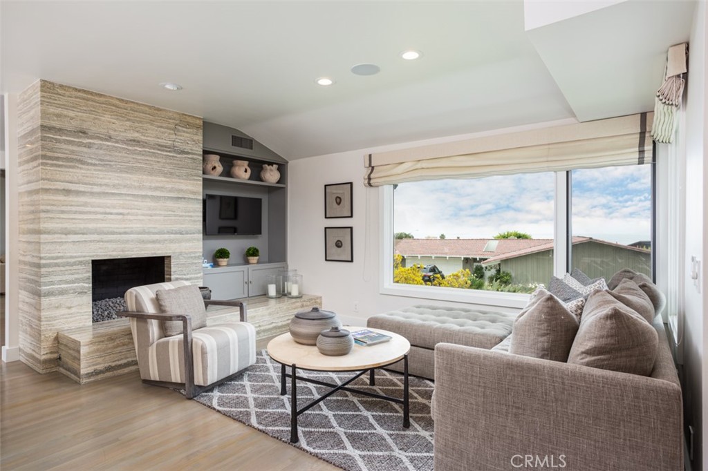 704 Emerald Bay Laguna Beach, CA 92651 - Photo 8 of 27 a living room with fireplace furniture and a large window