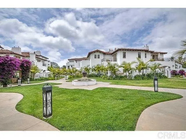 a view of a big house with a big yard and a large trees
