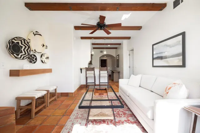 a living room with a couch and a rug