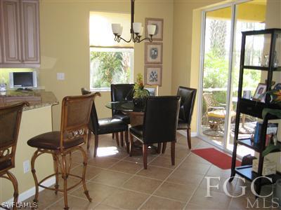 13002 Pennington Place, Unit 101 Fort Myers, FL 33913 - Photo 2 of 10 a view of a dining room with furniture window and outside view