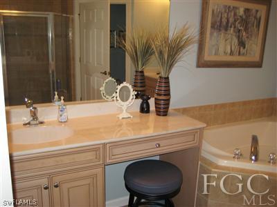 13002 Pennington Place, Unit 101 Fort Myers, FL 33913 - Photo 7 of 10 a bathroom with a sink and a mirror