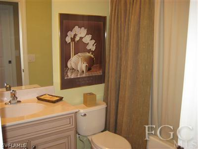 13002 Pennington Place, Unit 101 Fort Myers, FL 33913 - Photo 9 of 10 a bathroom with a sink and a mirror