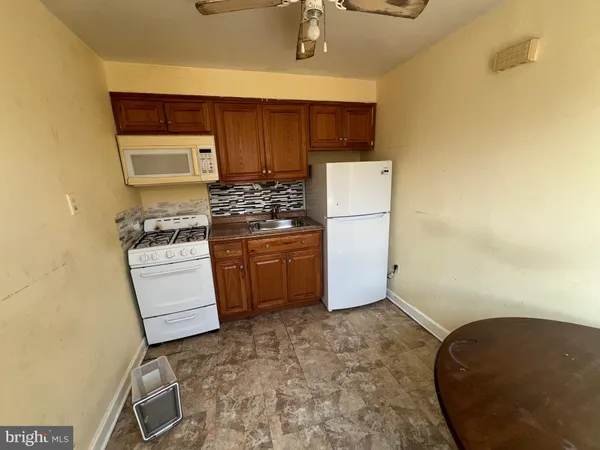 a kitchen with stainless steel appliances a stove a refrigerator and cabinets