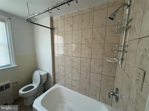a bathroom with a toilet sink and shower