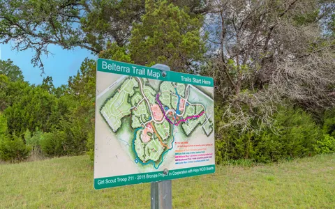 a view of swimming pool with seating space and yard in the back