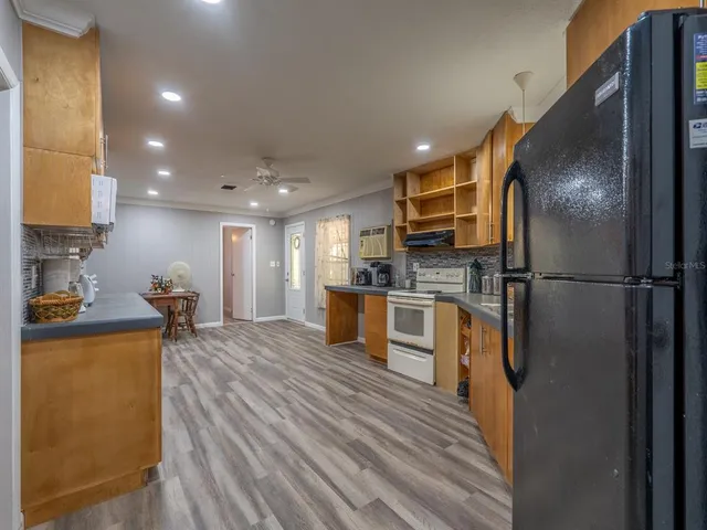 a kitchen with stainless steel appliances granite countertop a refrigerator sink and cabinets