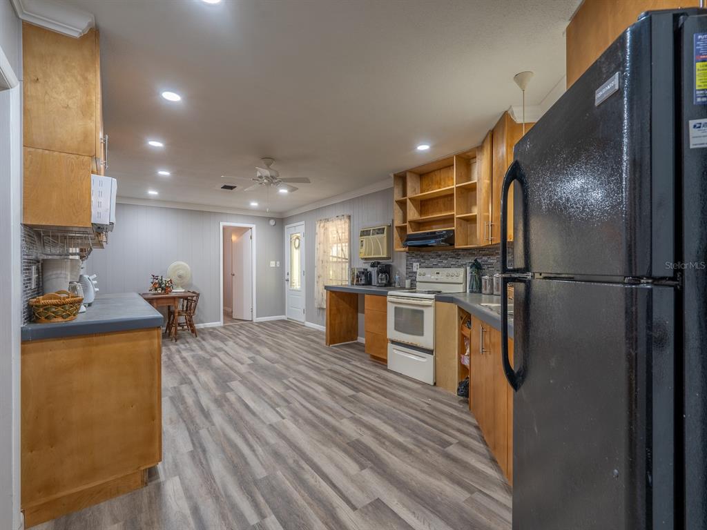 13455 Northeast 228 Ln Road Fort McCoy, FL 32134 - Photo 12 of 51 a kitchen with stainless steel appliances granite countertop a refrigerator sink and cabinets