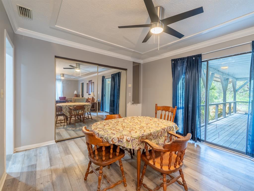 13455 Northeast 228 Ln Road Fort McCoy, FL 32134 - Photo 16 of 51 a view of a dining room with furniture and window