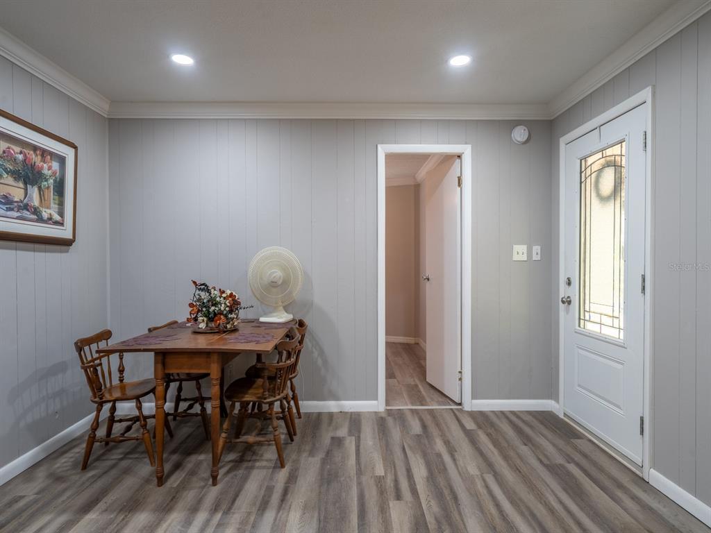 13455 Northeast 228 Ln Road Fort McCoy, FL 32134 - Photo 17 of 51 a view of a dining room with furniture and wooden floor