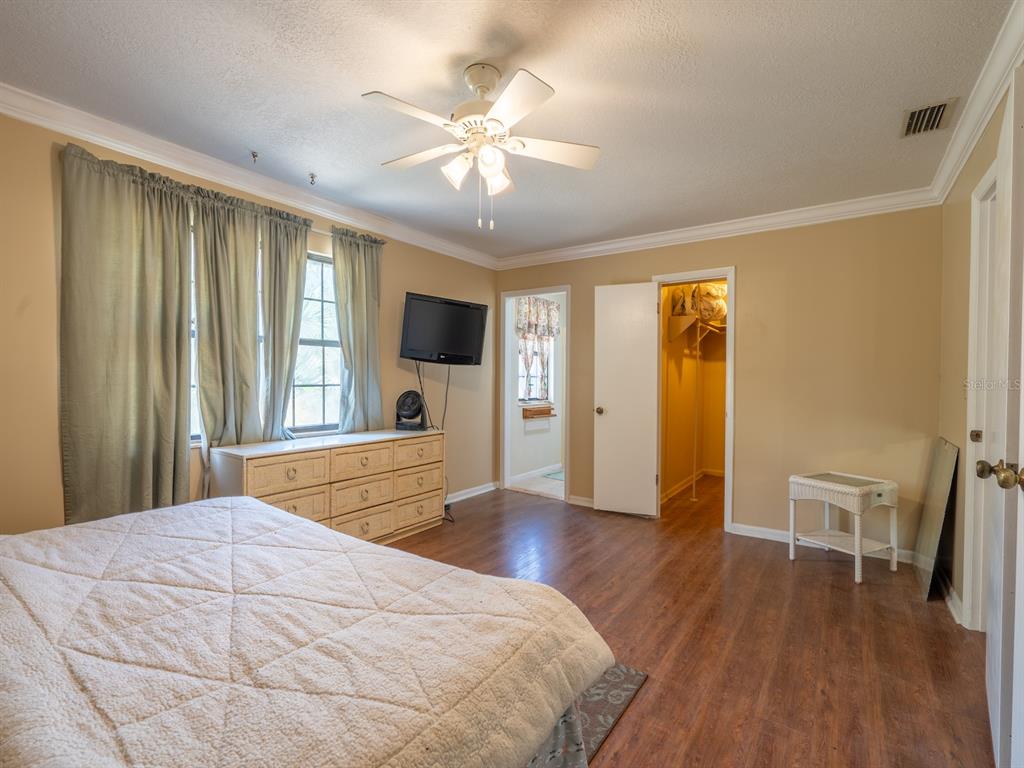 13455 Northeast 228 Ln Road Fort McCoy, FL 32134 - Photo 21 of 51 a bedroom with a bed and a flat screen tv