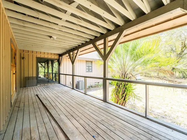 a view of balcony with wooden floor