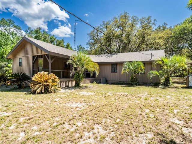 a view of a house with backyard porch and furniture