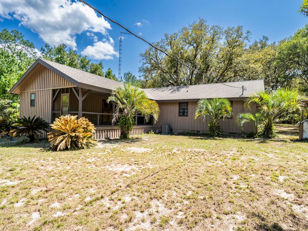 13455 Northeast 228 Ln Road Fort McCoy, FL 32134 - Photo 46 of 51 a view of a house with backyard porch and furniture