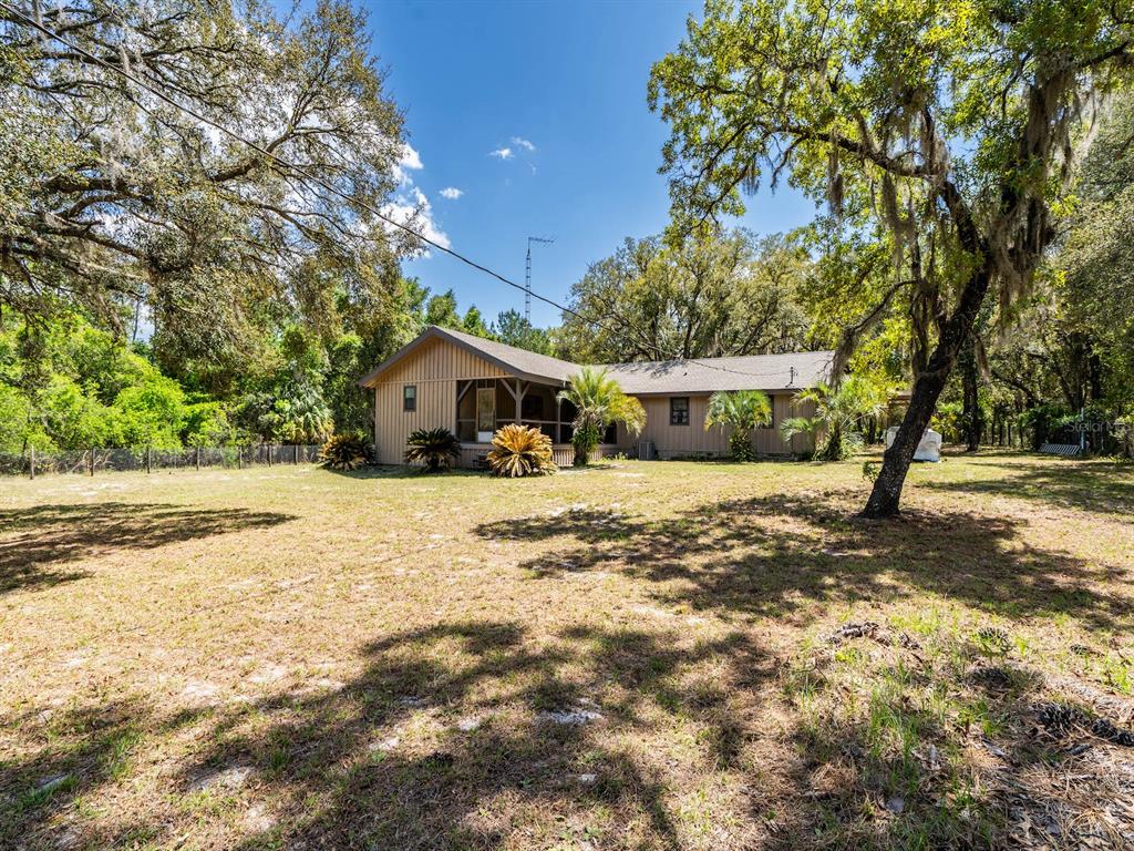 13455 Northeast 228 Ln Road Fort McCoy, FL 32134 - Photo 49 of 51 a front view of a house with a yard and garage